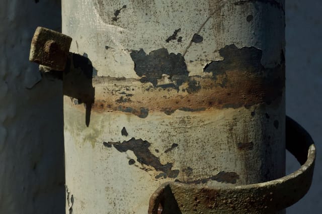 Corroded steel vessel with breakdown of the protective coating and surface pitting