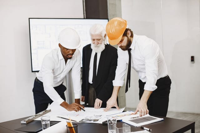 Engineers reviewing repair drawings together at a table