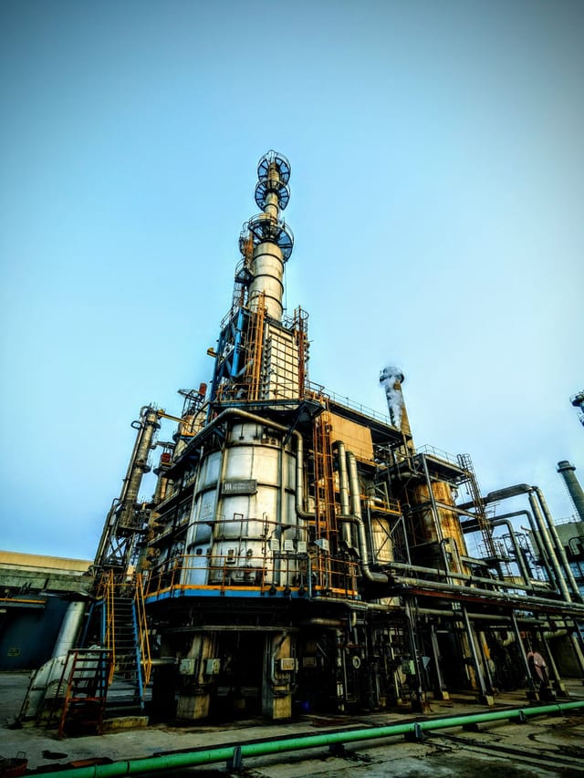 Tall refinery distillation columns and process structure against a blue sky