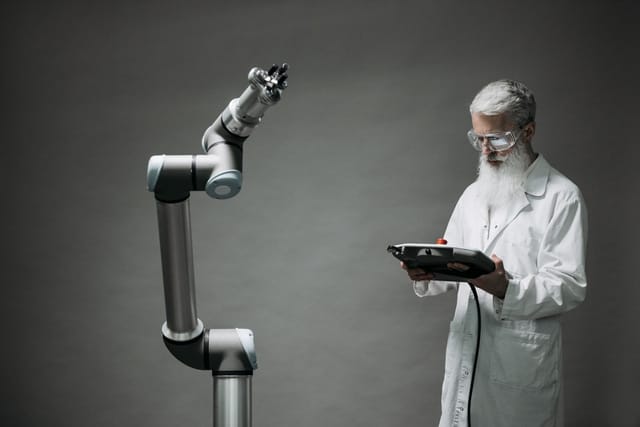 Operator controlling a crawler from a handheld unit while standing clear of the equipment