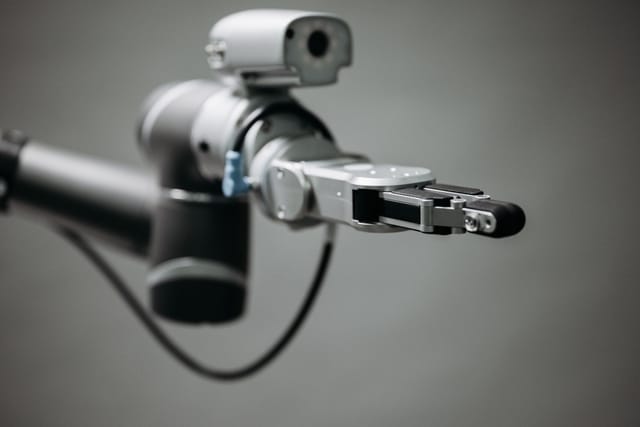 Articulated inspection camera head on a manipulator against a plain background