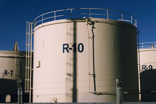 A range of industrial storage tanks of different sizes at a fuel storage facility