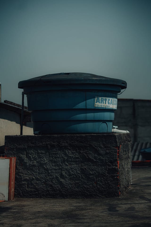 Moulded polyethylene plastic storage tank on a raised base
