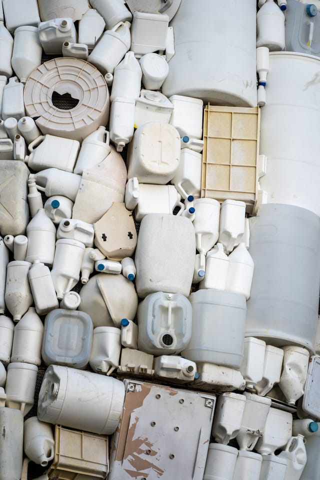 White high-density plastic containers and vessels stacked together